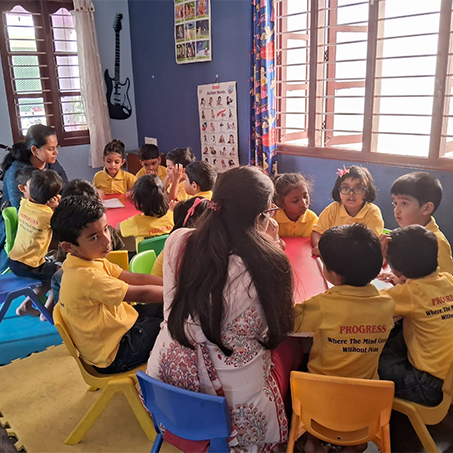 Children learning with teachers in a Progress Preschool classroom